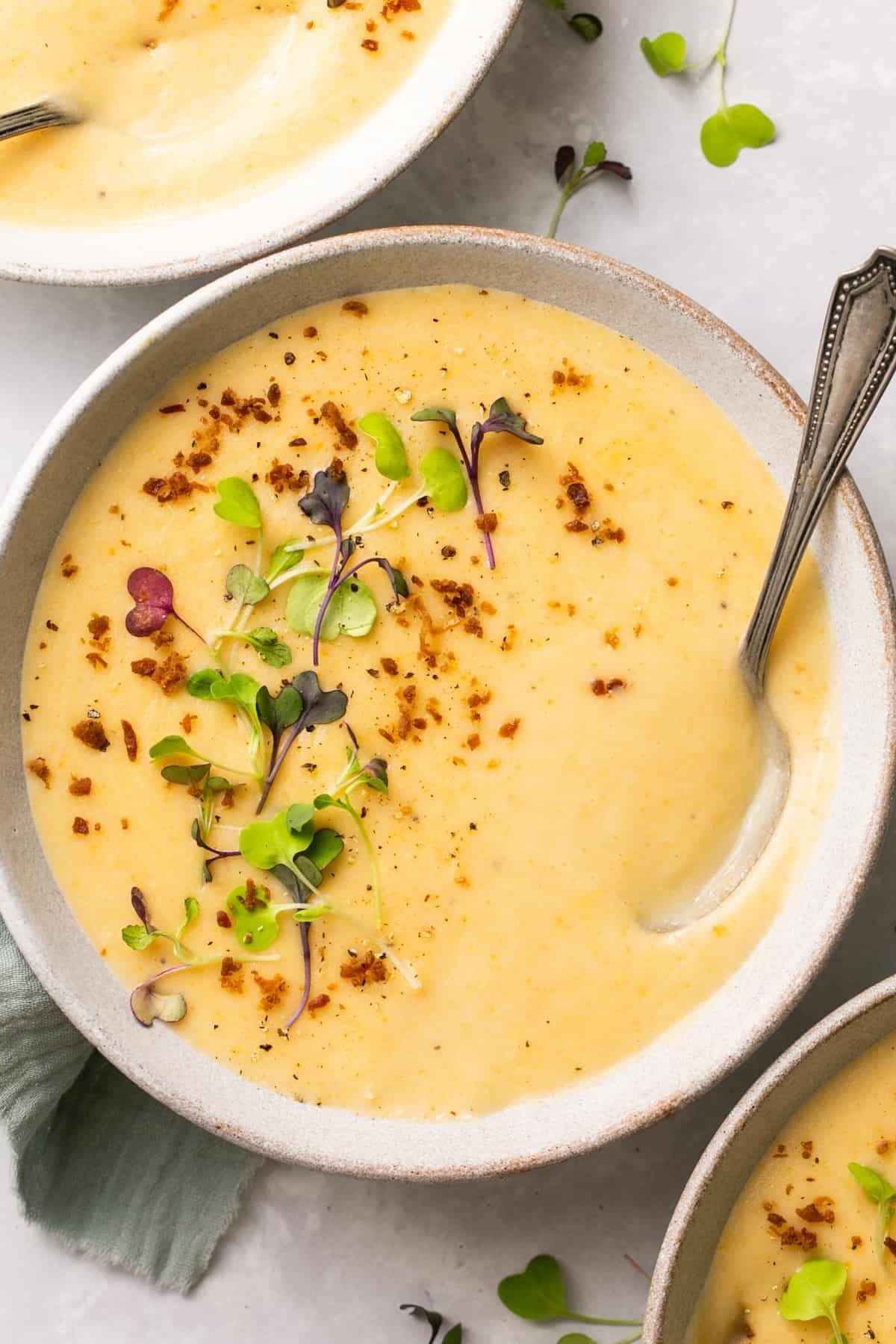 comforting bowl of creamy herb potato soup with fresh garnishes