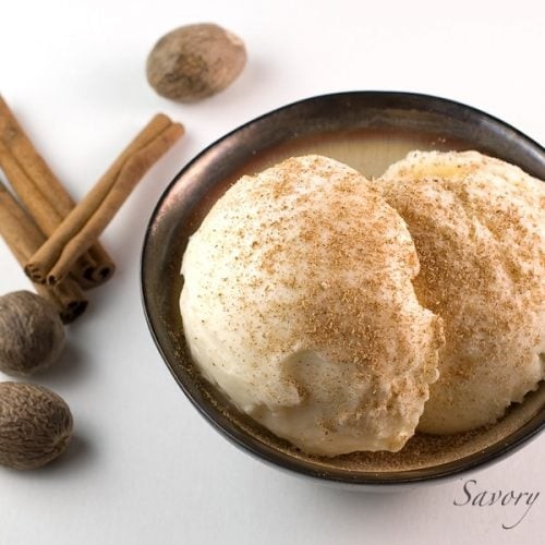 bowls of eggnog frozen yogurt with cinnamon sticks and nutmeg