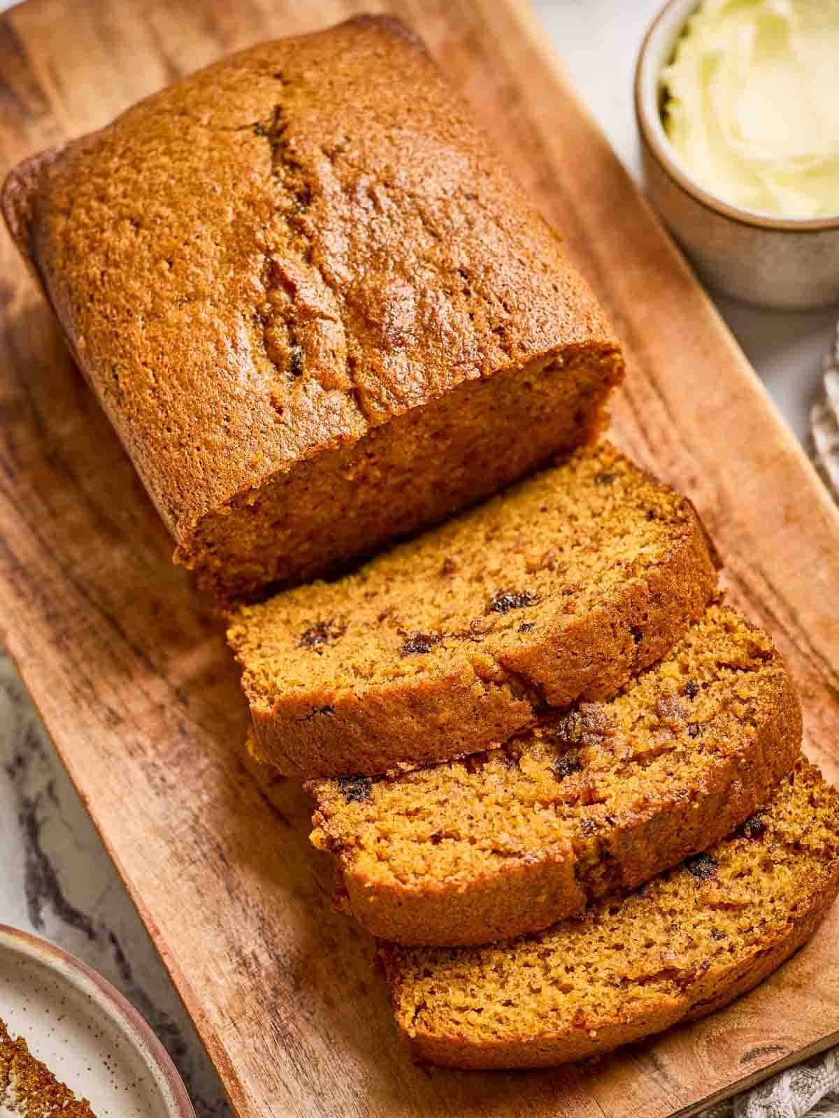 slices of moist pumpkin bread on a wooden board