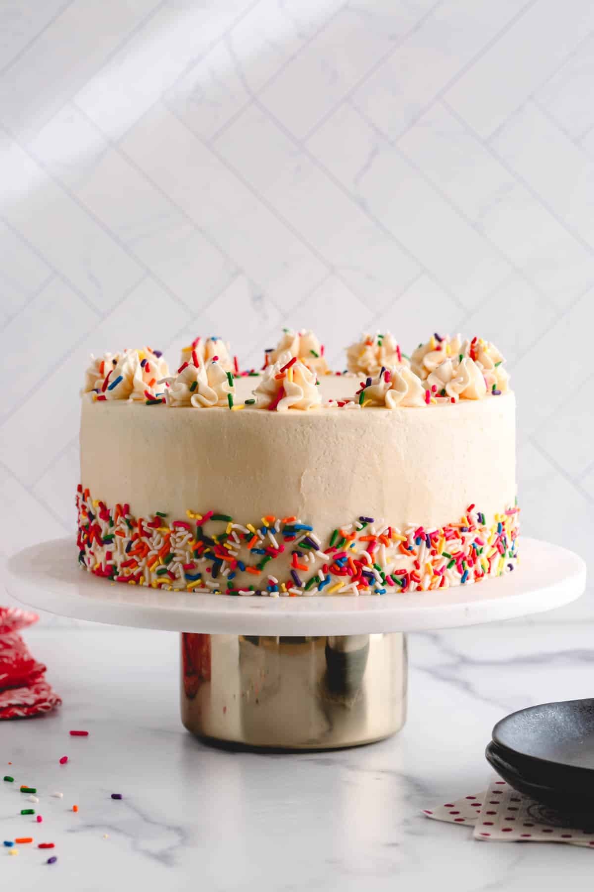 vanilla birthday cake with nigella seeds and white frosting