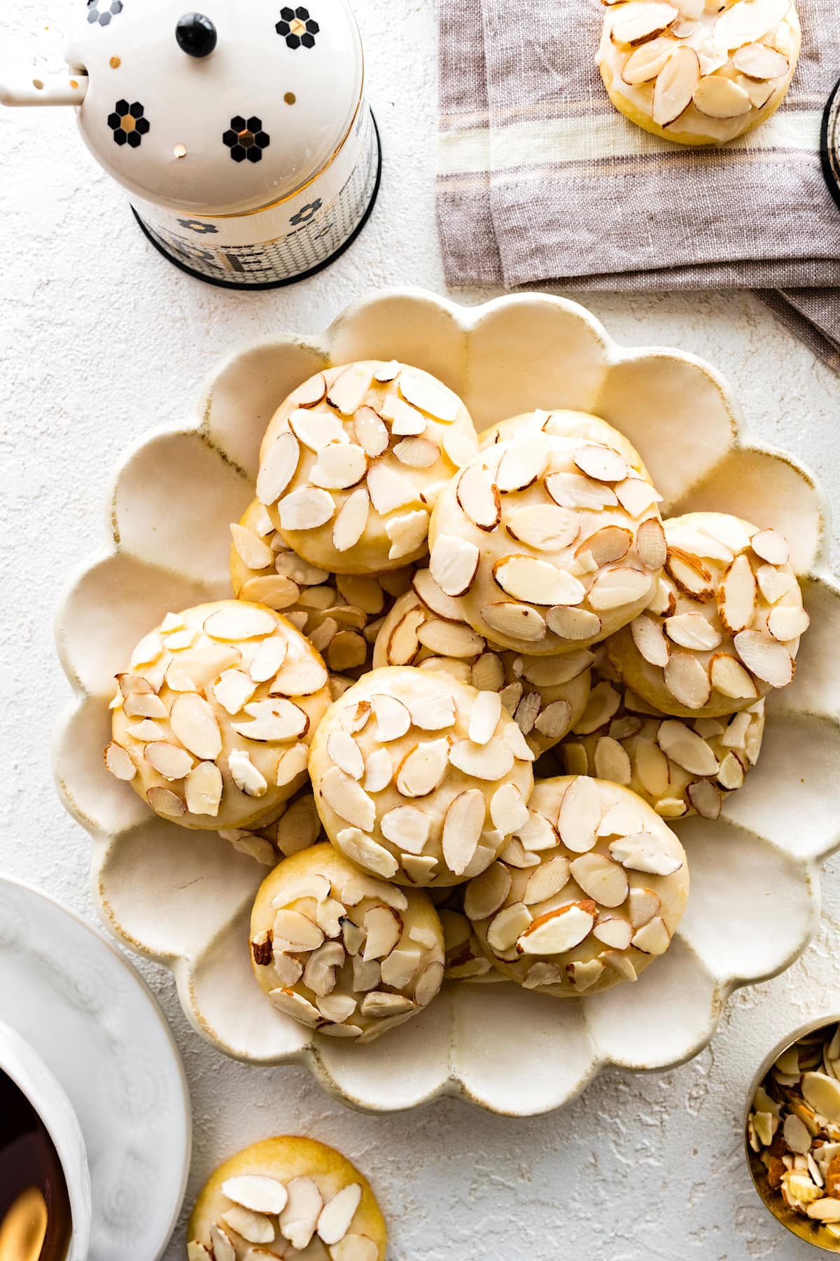 Beautifully decorated almond cookies on a platter