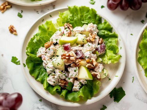 close up shot of date walnut chicken salad on a plate with lettuce and crackers