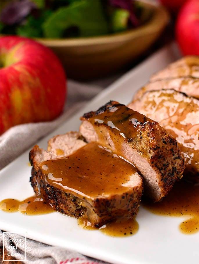 Close-up shot of the maple Dijon glazed pork tenderloin being sliced, showcasing its juicy texture