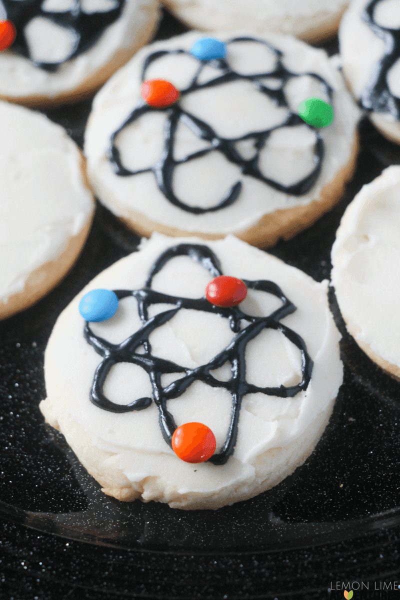 overhead shot of colorful, swirled sugar cookies with a science theme, like beakers or atoms
