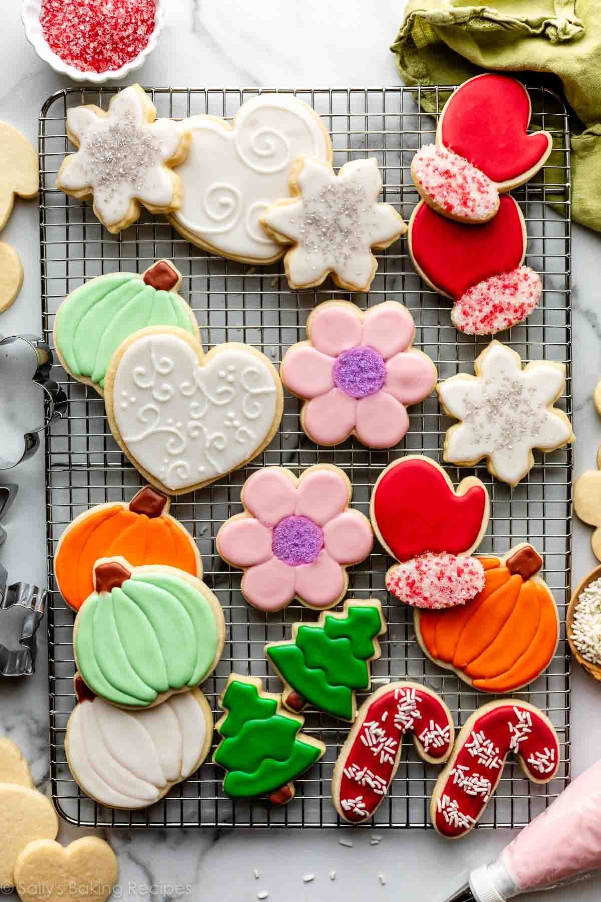 Beautifully decorated shortbread cookies with intricate royal icing designs on a cooling rack