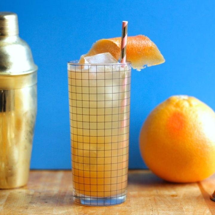 Earl Grey Grapefruit Hugo cocktail in a highball glass with grapefruit peel garnish