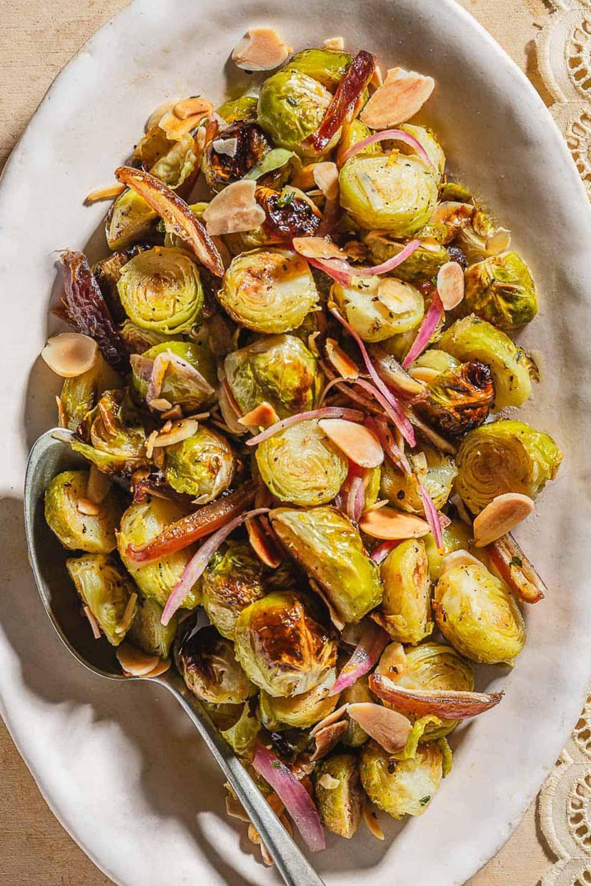 Roasted Brussels sprouts with dates and almonds on a plate
